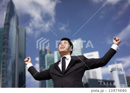 Asian Man holding his hands high in celebration 13974680