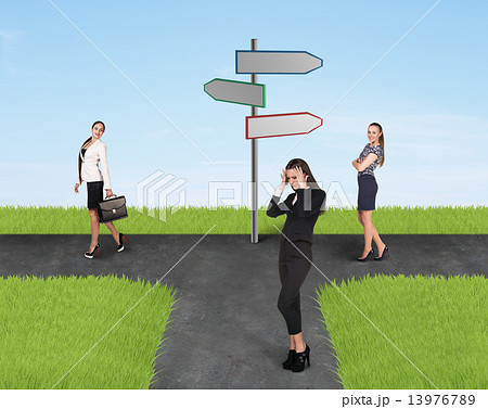Three businesswomen and road sign 13976789