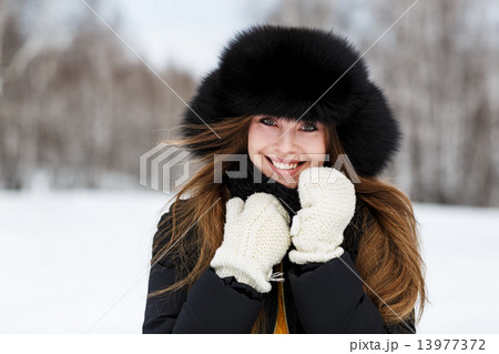 Portrait of happy young woman in luxury fur hat Portrait of happy young woman in luxury fur hat 13977372