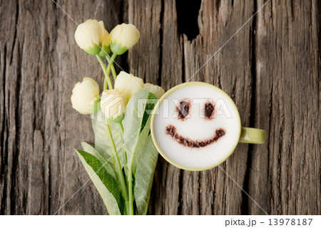 Wood background and happy coffee cup with spring flowers. 13978187