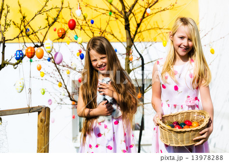 Girl on Easter egg hunt with living Easter Bunny Girl on Easter egg hunt with living Easter Bunny 13978288