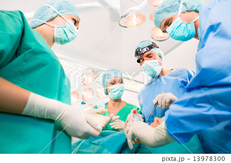 Surgeons in operating room in emergency Surgeons in operating room in emergency 13978300