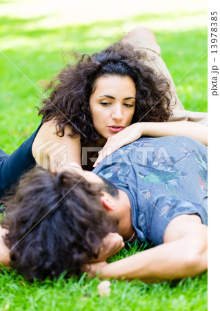 Latin Couple on meadow sleeping in summer Latin Couple on meadow sleeping in summer 13978385