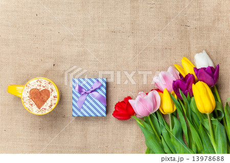 Cappuccino and gift box near flowers 13978688