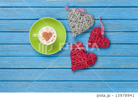 Cup of Cappuccino with heart shape symbol and toys 13978941