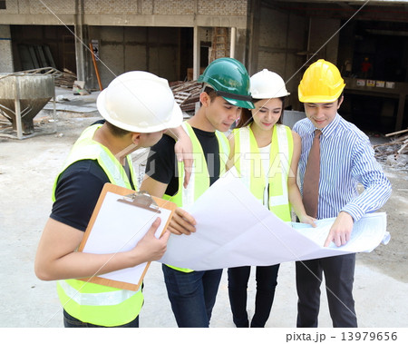 man woman at construction sight worker executive reading plan 13979656