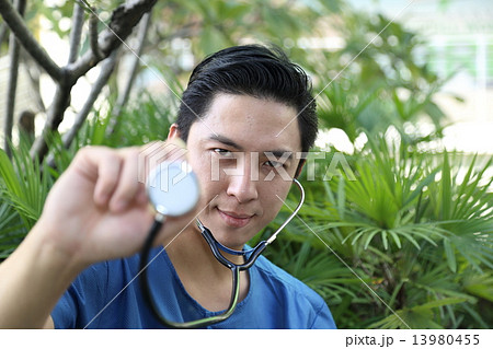 Male doctor surgeon holding stethoscope focus face Male doctor surgeon holding stethoscope focus face 13980455