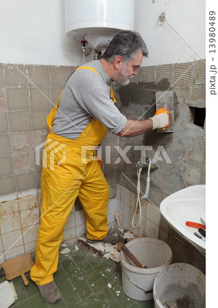 Home renovation, mason fixing wall 13980489