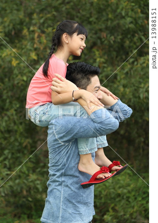 Father daughter piggyback at park Father daughter piggyback at park 13988151