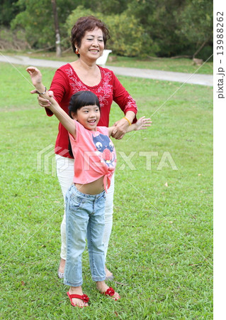 Family Grandmother and granddaughter play exercise at park Family Grandmother and granddaughter play exercise at park 13988262