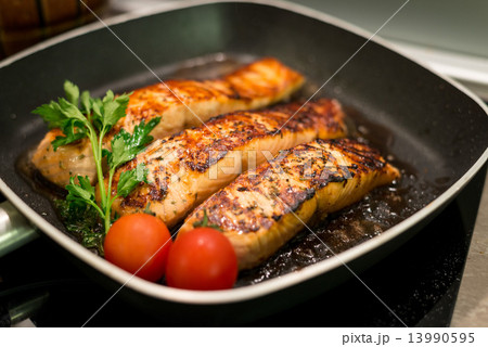 Fresh salmon filles grilled in a pan Fresh salmon filles grilled in a pan 13990595