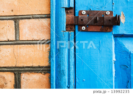 closed metal latch on blue painted woooden door 13992235