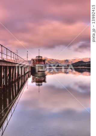 Scenic view of boats moored by wooden pier , Lake District National Park, England. 13992415