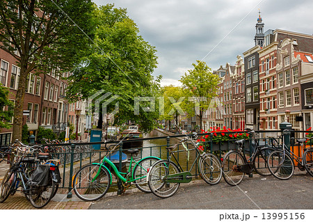 City view of Amsterdam canals and typical houses, Holland, Nethe 13995156