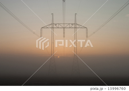Power-transmission pole in the mist in winter nature Power-transmission pole in the mist in winter nature 13996760