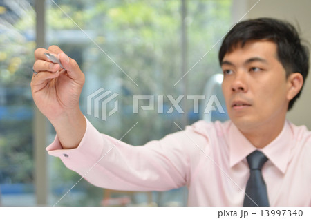 Handsome Business man writing with pen in the air 13997340