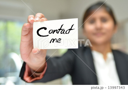 An attractive businesswoman presenting her business card 13997343