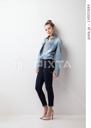 Portrait of woman standing against wall Portrait of woman standing against wall 14005884