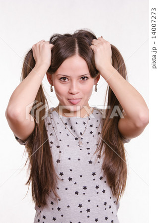 Grimacing girl with protruding tongue 14007273