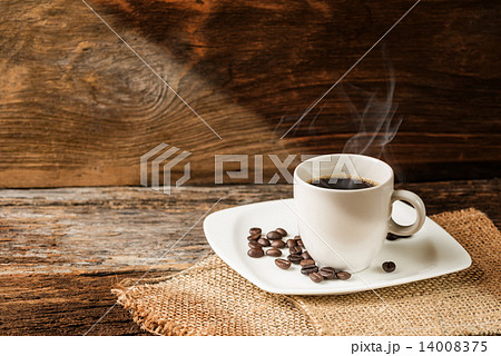 warm cup of coffee on old wooden background warm cup of coffee on old wooden background 14008375