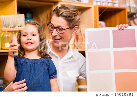 Family with paint sample card in store Family with paint sample card in store 14010891