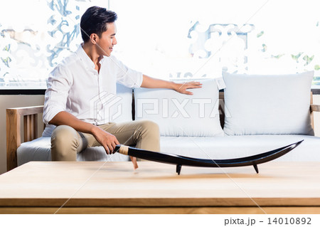 Asian man on sofa couch in furniture store Asian man on sofa couch in furniture store 14010892