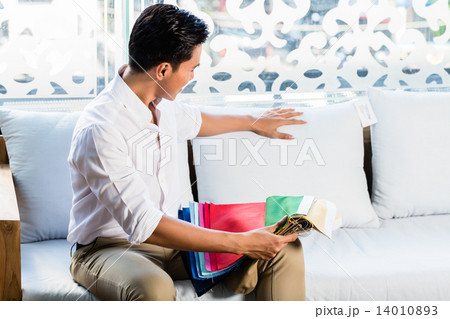 Asian man on sofa couch in furniture store Asian man on sofa couch in furniture store 14010893