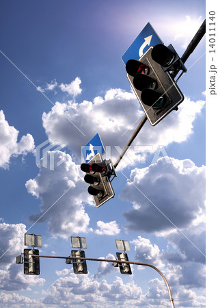 Traffic lights against a vibrant blue sky with clouds. 14011140