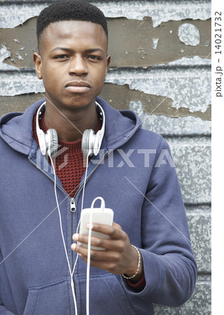 Teenage Boy Wearing Headphones And Listening To Music In Urban S Teenage Boy Wearing Headphones And Listening To Music In Urban S 14021732
