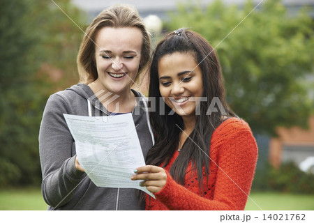 Two Female Students Celebrating Exam Results Together Two Female Students Celebrating Exam Results Together 14021762