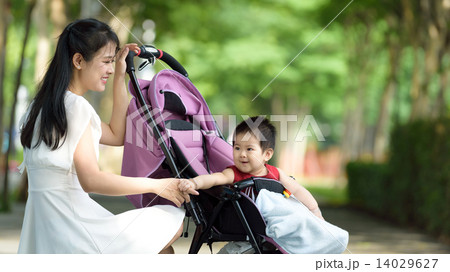 Chinese mother with baby in a stroller Chinese mother with baby in a stroller 14029627
