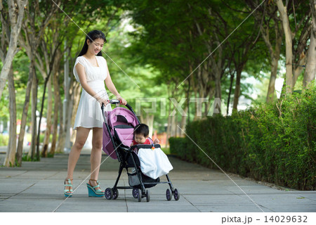 Chinese mother pushing baby in a stroller 14029632
