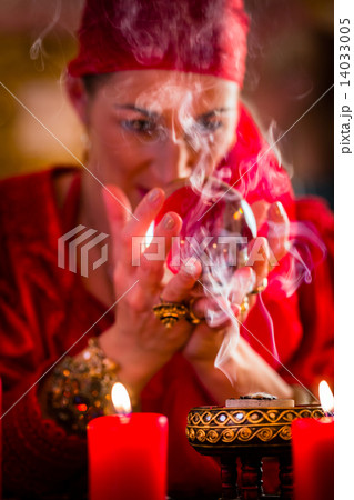 Soothsayer in Seance with Crystal ball and smoke 14033005