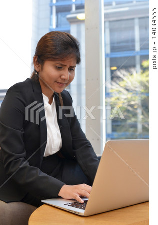 Young indian businesswoman is using laptop computer. Young indian businesswoman is using laptop computer. 14034555