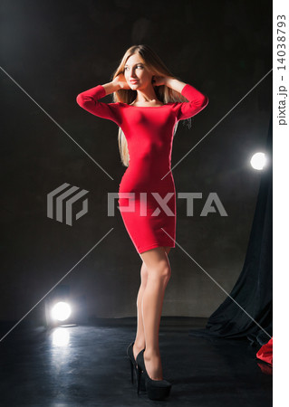 Glamorous smiling young woman standing on stage . Glamorous smiling young woman standing on stage . 14038793