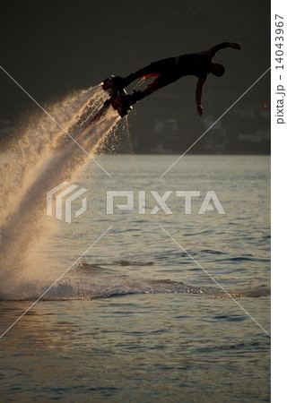Flyboarder turns into high dive at dusk Flyboarder turns into high dive at dusk 14043967