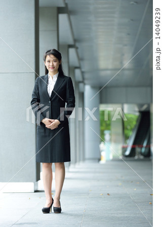 Successful chinese businesswoman along office building walkway Successful chinese businesswoman along office building walkway 14049239