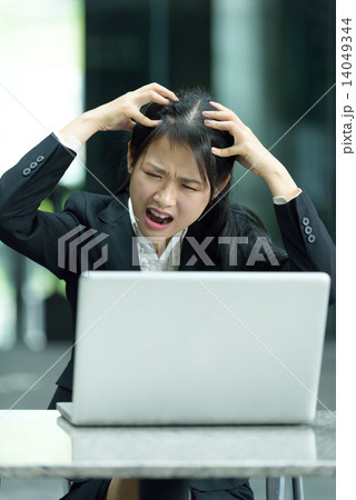 Chinese businesswoman having a bad day at work Chinese businesswoman having a bad day at work 14049344