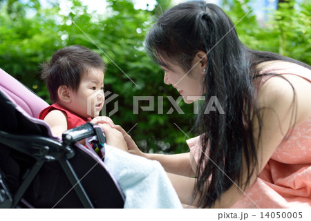 Chinese mother and baby playing along promenade Chinese mother and baby playing along promenade 14050005