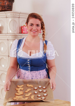 Young girl with a baking tray full of cookies 14050699