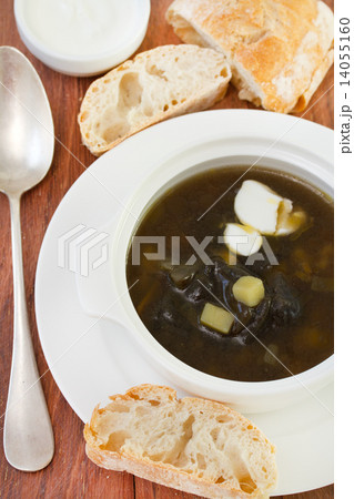 soup in white bowl on plate with bread soup in white bowl on plate with bread 14055160