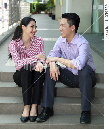 Man woman business executive outdoor pose relax sit on stair Man woman business executive outdoor pose relax sit on stair 14059759