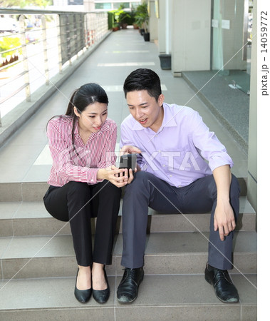 Man woman business executive  outdoor pose relax sit on stair phone 14059772
