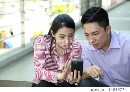 Man woman business executive  outdoor pose relax sit on stair phone 14059774