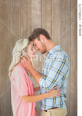 Composite image of attractive couple smiling at each other and h Composite image of attractive couple smiling at each other and h 14061173