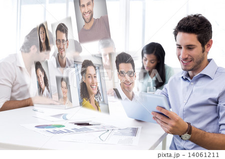 Composite image of attractive businessman using a tablet at work Composite image of attractive businessman using a tablet at work 14061211