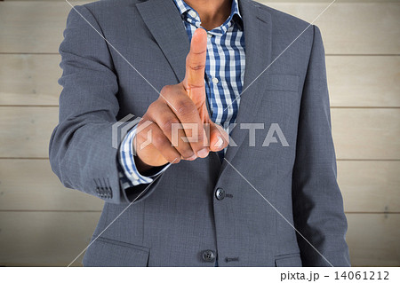 Composite image of focused businessman pointing Composite image of focused businessman pointing 14061212