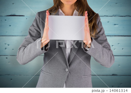 Composite image of businesswoman showing a card 14061314