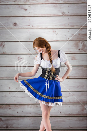 Composite image of oktoberfest girl spreading her skirt Composite image of oktoberfest girl spreading her skirt 14061317