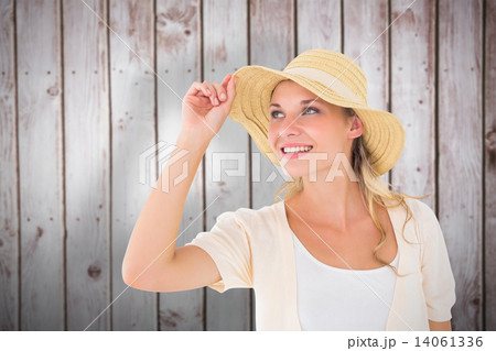 Composite image of attractive young blonde smiling in sunhat 14061336